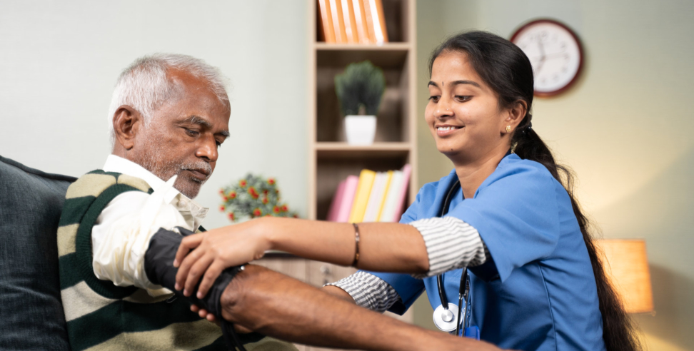 caregiver assisting senior woman to stand up