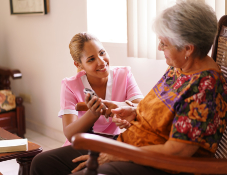 caregiver and senior woman smiling