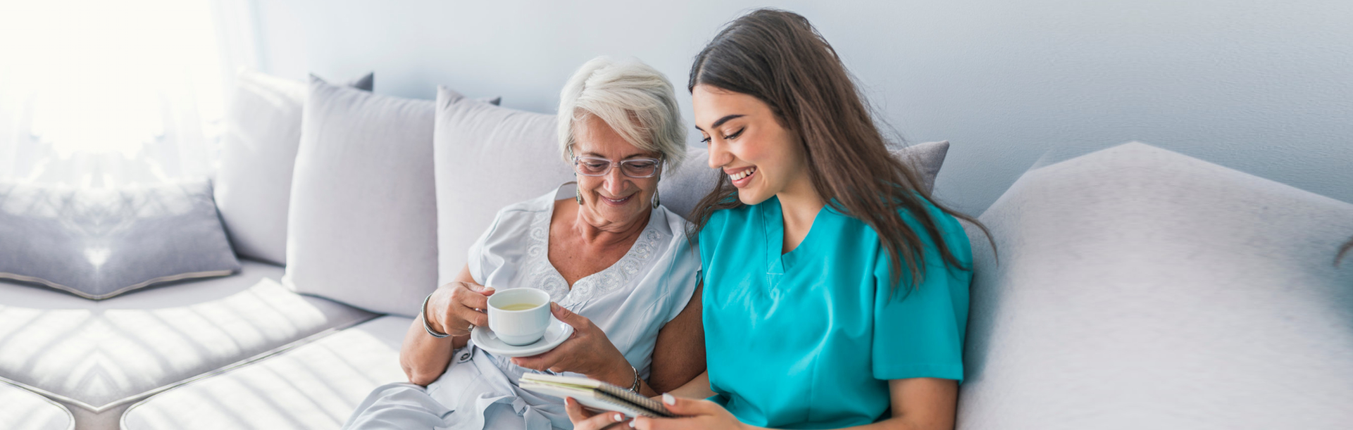 caregiver assisting senior man to stand