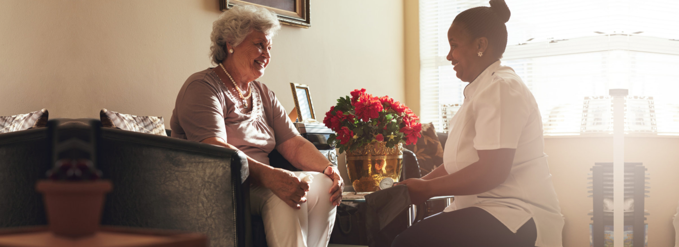 caregiver looking at a senior woman